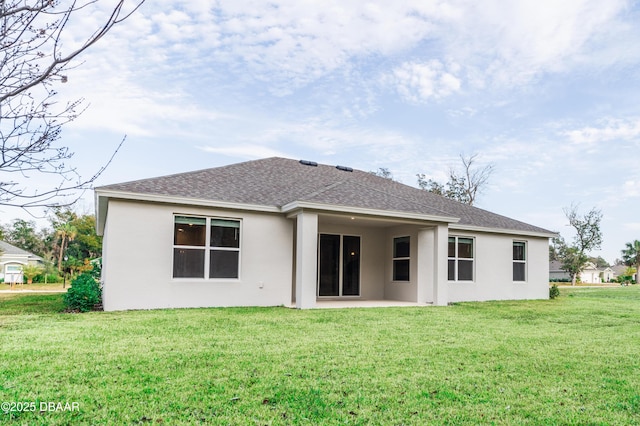 back of house featuring a patio area and a lawn