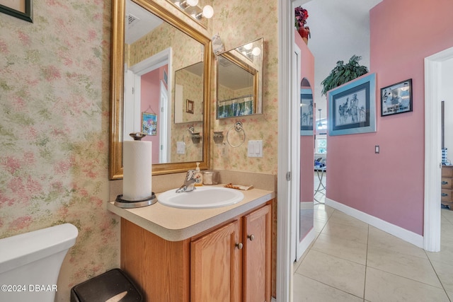 316 Dahoon Holly Dr, Daytona Beach, FL 32117 - bathroom featuring vanity, wallpapered walls, toilet, tile patterned flooring, and baseboards