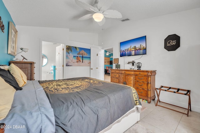 316 Dahoon Holly Dr, Daytona Beach, FL 32117 - bedroom with vaulted ceiling, a textured ceiling, light tile patterned floors, a ceiling fan, and ensuite bath