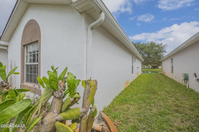 316 Dahoon Holly Dr, Daytona Beach, FL 32117 - view of side of property featuring stucco siding and a lawn