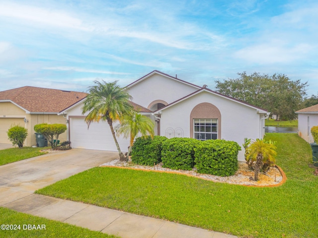 316 Dahoon Holly Dr, Daytona Beach, FL 32117 - view of front of property featuring concrete driveway, a front lawn, stucco siding, and a garage