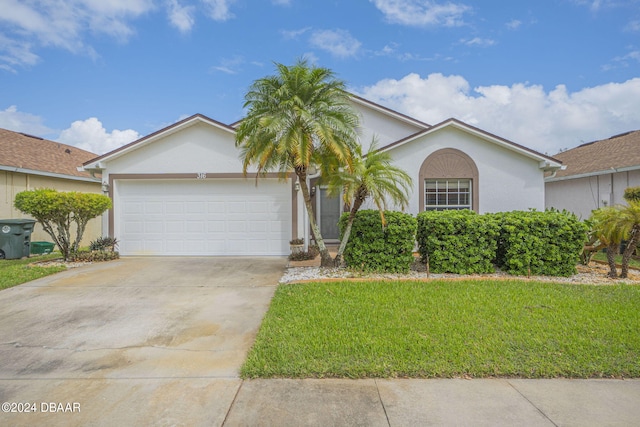 316 Dahoon Holly Dr, Daytona Beach, FL 32117 - single story home with stucco siding, a garage, a front lawn, and concrete driveway