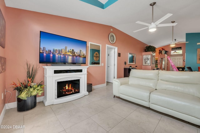 316 Dahoon Holly Dr, Daytona Beach, FL 32117 - living area with vaulted ceiling, ceiling fan, baseboards, a warm lit fireplace, and tile patterned flooring
