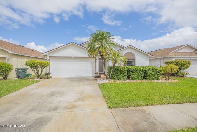 316 Dahoon Holly Dr, Daytona Beach, FL 32117 - single story home with stucco siding, a front yard, an attached garage, and concrete driveway