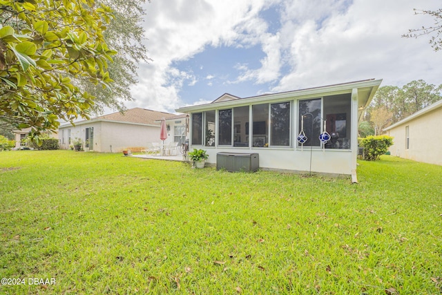 316 Dahoon Holly Dr, Daytona Beach, FL 32117 - back of property featuring a sunroom, a lawn, and a patio area
