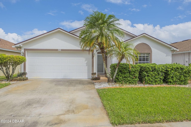 view of front of home with a garage and a front lawn