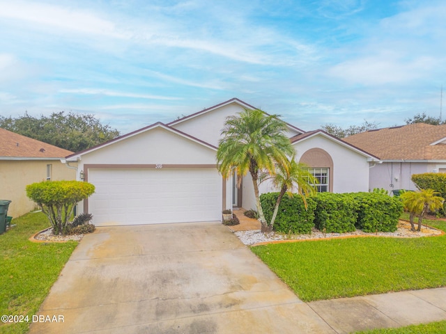 316 Dahoon Holly Dr, Daytona Beach, FL 32117 - view of front facade featuring stucco siding, a front yard, driveway, and a garage