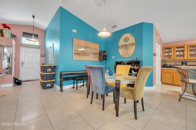 316 Dahoon Holly Dr, Daytona Beach, FL 32117 - dining area featuring vaulted ceiling, light tile patterned floors, and baseboards
