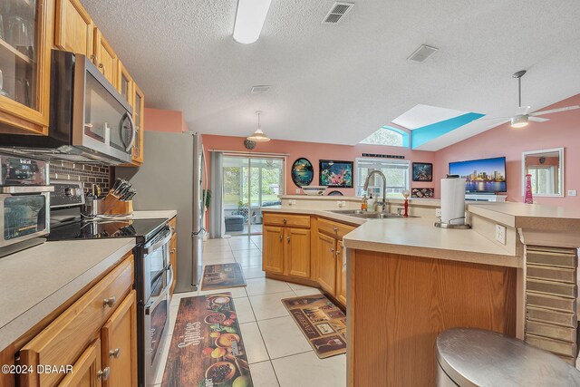 316 Dahoon Holly Dr, Daytona Beach, FL 32117 - kitchen with a sink, stainless steel appliances, ceiling fan, light countertops, and a textured ceiling