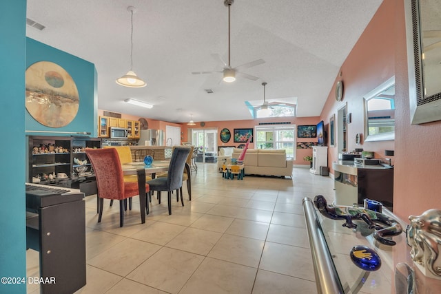 316 Dahoon Holly Dr, Daytona Beach, FL 32117 - dining space with ceiling fan, a textured ceiling, light tile patterned floors, and vaulted ceiling