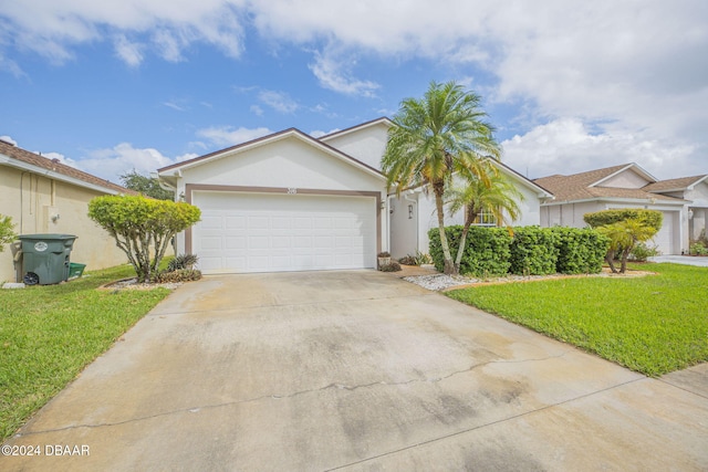 316 Dahoon Holly Dr, Daytona Beach, FL 32117 - ranch-style house with concrete driveway, a front lawn, stucco siding, and a garage