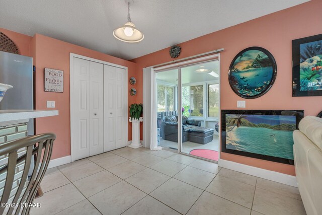 316 Dahoon Holly Dr, Daytona Beach, FL 32117 - foyer with baseboards, a textured ceiling, and light tile patterned floors