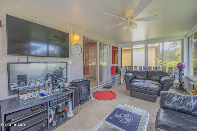 316 Dahoon Holly Dr, Daytona Beach, FL 32117 - living area featuring ceiling fan, tile patterned floors, a textured wall, and a wood stove