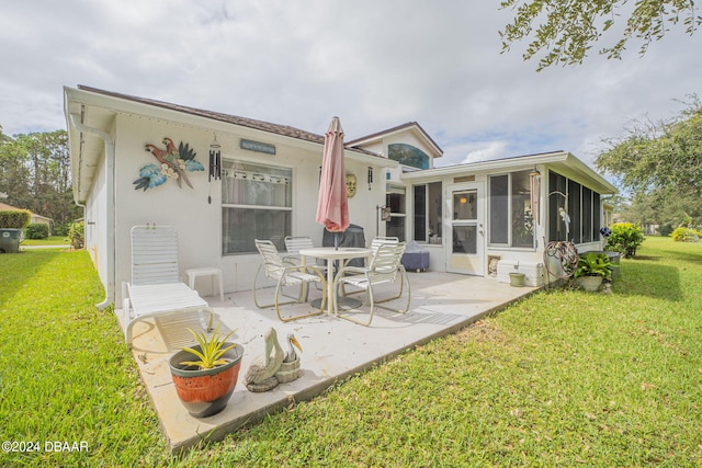 316 Dahoon Holly Dr, Daytona Beach, FL 32117 - back of house with a patio, a sunroom, a yard, and stucco siding