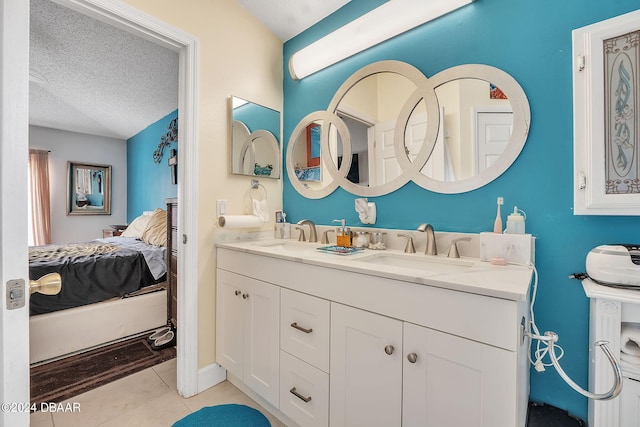 316 Dahoon Holly Dr, Daytona Beach, FL 32117 - full bathroom featuring connected bathroom, double vanity, a textured ceiling, and tile patterned flooring