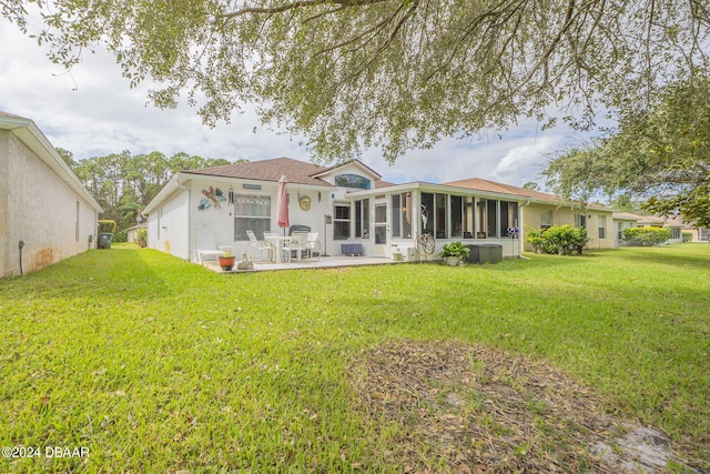 316 Dahoon Holly Dr, Daytona Beach, FL 32117 - rear view of property with a sunroom, a patio, and a yard