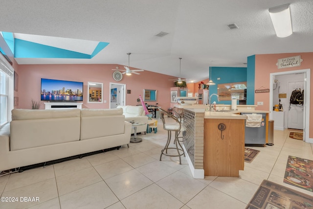 316 Dahoon Holly Dr, Daytona Beach, FL 32117 - kitchen featuring a sink, open floor plan, a ceiling fan, light countertops, and vaulted ceiling