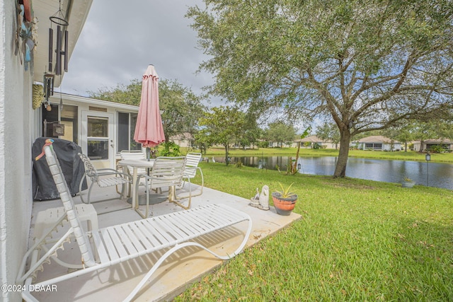 316 Dahoon Holly Dr, Daytona Beach, FL 32117 - view of grassy yard featuring a water view, a patio, and outdoor dining space