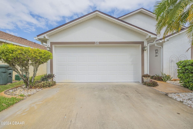 316 Dahoon Holly Dr, Daytona Beach, FL 32117 - view of front of home featuring stucco siding, driveway, and a garage