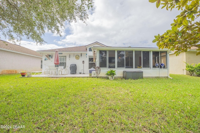 316 Dahoon Holly Dr, Daytona Beach, FL 32117 - rear view of property featuring a sunroom, a yard, a patio, and central AC