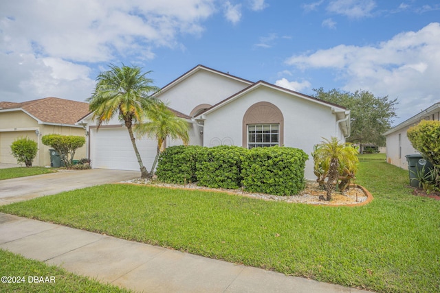 316 Dahoon Holly Dr, Daytona Beach, FL 32117 - view of front facade with driveway, a garage, a front lawn, and stucco siding