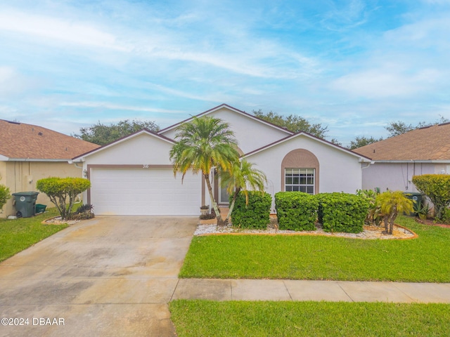 single story home featuring a garage and a front yard