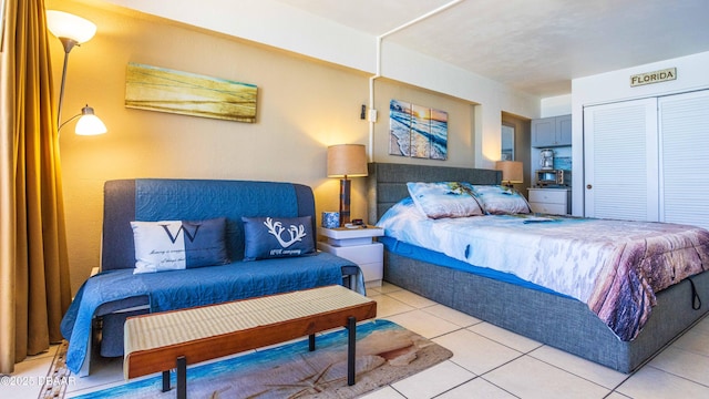 bedroom with a closet and light tile patterned floors