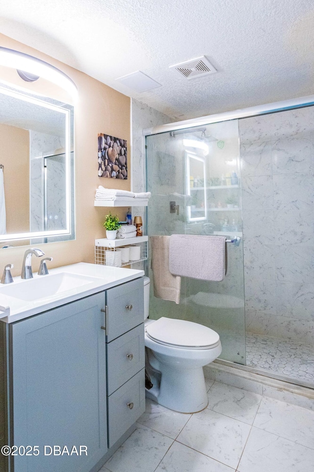 bathroom with visible vents, marble finish floor, a stall shower, and vanity