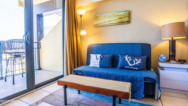 bedroom featuring tile patterned flooring and access to exterior