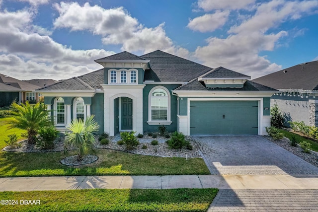 view of front of home with a garage and a front yard