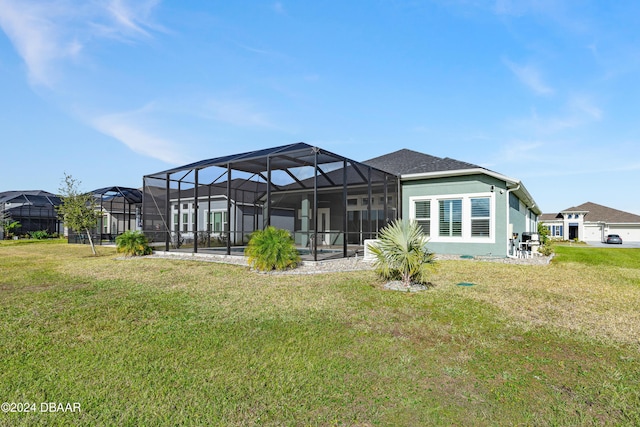 back of property with a yard and glass enclosure