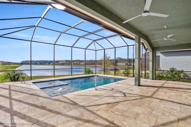 view of swimming pool featuring ceiling fan, glass enclosure, a water view, and a patio