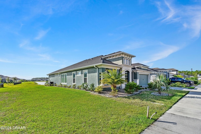 view of front of home with a garage and a front lawn