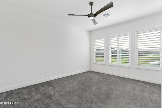 carpeted spare room with ceiling fan