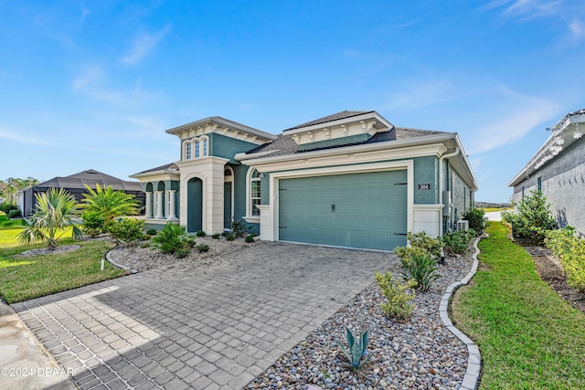 view of front of home with a garage and a front lawn