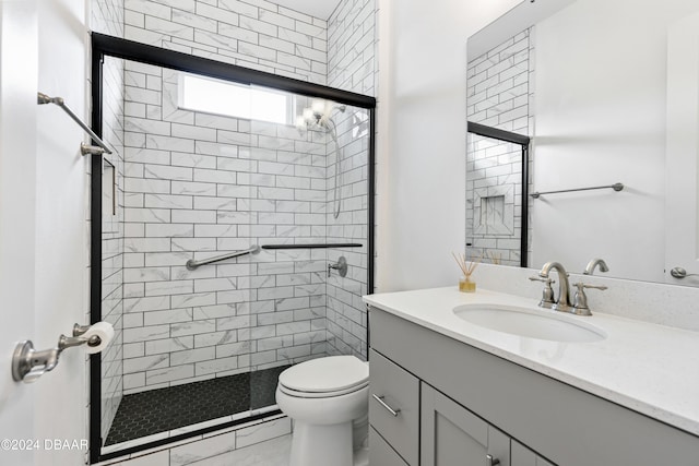 bathroom featuring vanity, toilet, and an enclosed shower