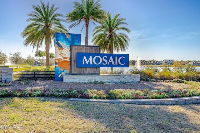 community / neighborhood sign featuring a lawn