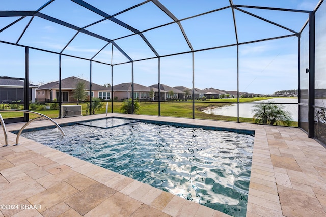 view of pool featuring glass enclosure, a lawn, a water view, and a patio