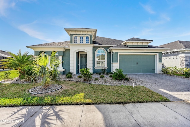 view of front of property featuring a front yard and a garage