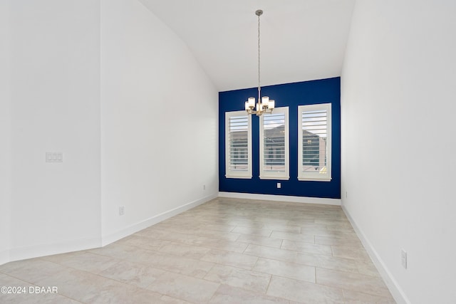 empty room featuring light tile patterned floors, vaulted ceiling, and an inviting chandelier