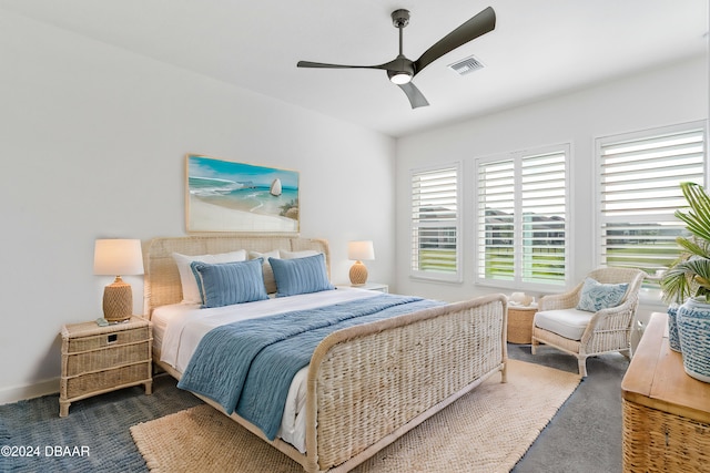 bedroom with ceiling fan and dark colored carpet