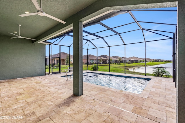 view of pool featuring a lanai, ceiling fan, a patio area, and a water view