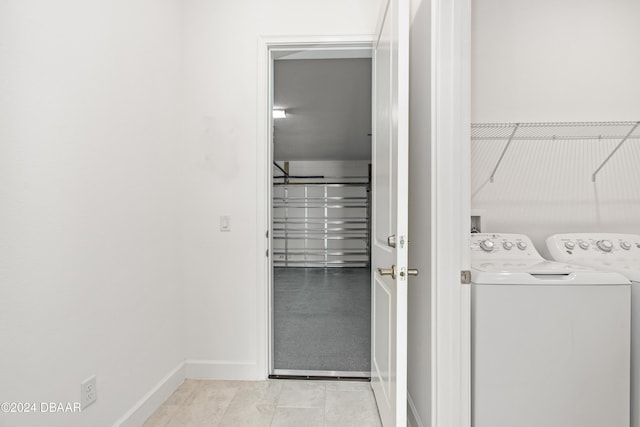 laundry room featuring washer and dryer and light tile patterned floors