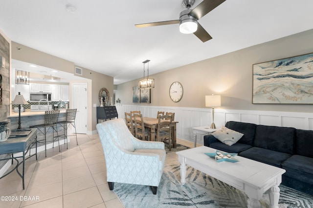 tiled living room featuring ceiling fan