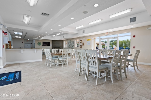 dining area with french doors and light tile patterned floors