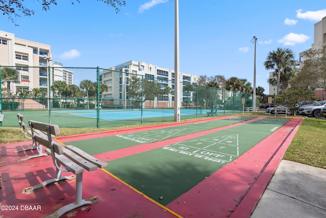 view of home's community with tennis court