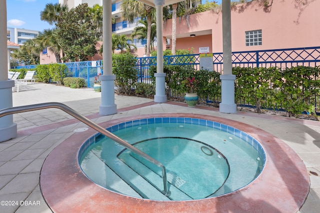 view of pool with a hot tub