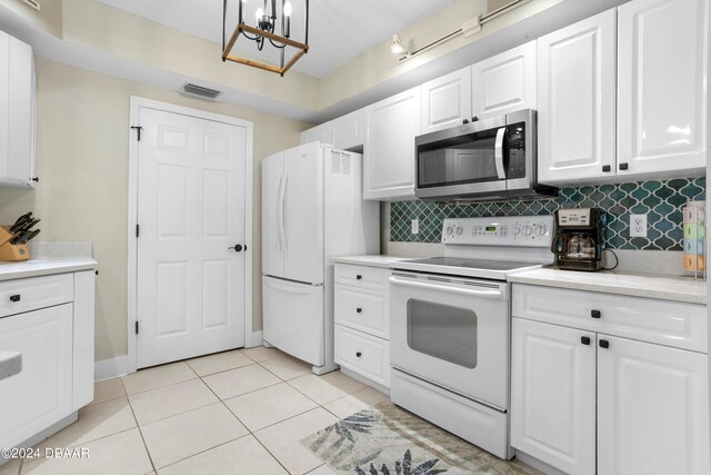 kitchen with white cabinets, tasteful backsplash, light tile patterned floors, and white appliances