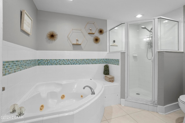 bathroom with tile patterned flooring, toilet, and independent shower and bath