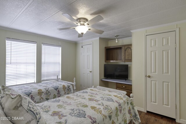 1420 Carol Lee St, Daytona Beach, FL 32117 - bedroom featuring multiple windows, ornamental molding, a textured ceiling, dark wood-type flooring, and a ceiling fan